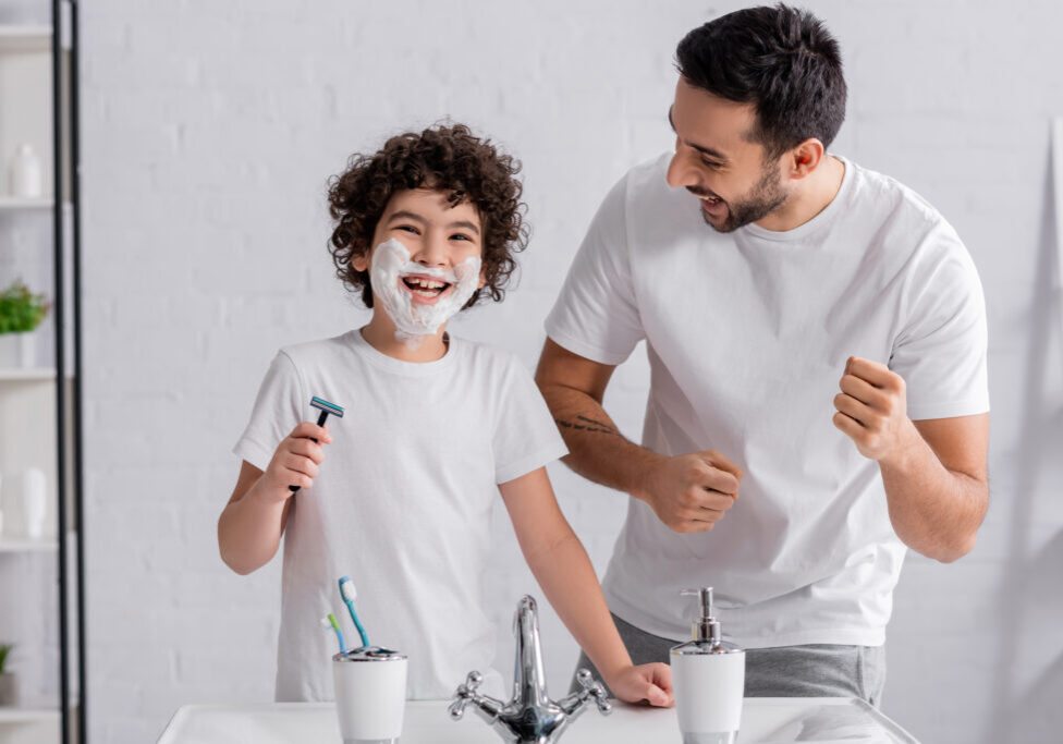 Cheerful,Man,Standing,Near,Son,With,Shaving,Foam,And,Razor