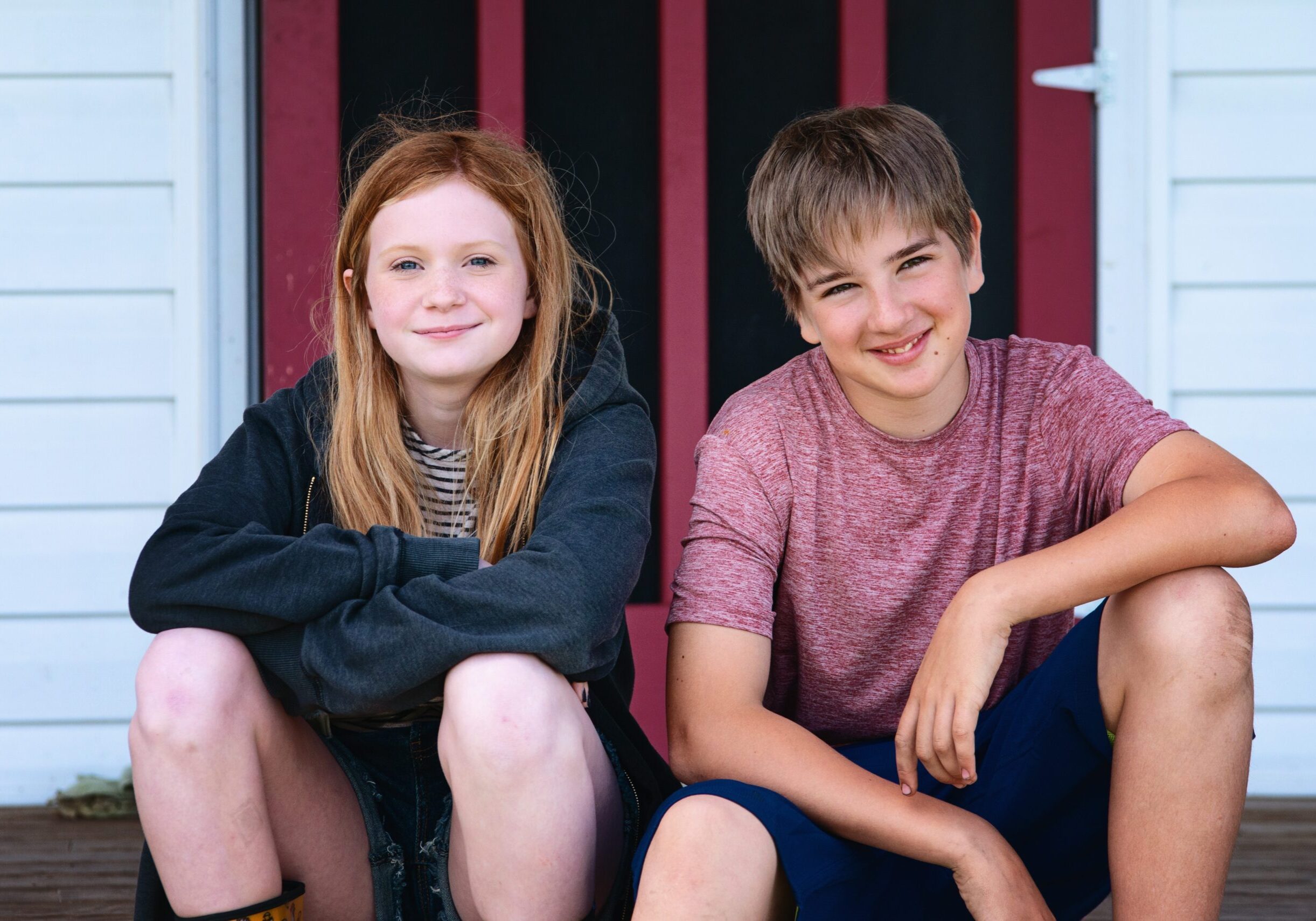 Tween,Boy,And,Girl,Sitting,On,Farmhouse,Steps.