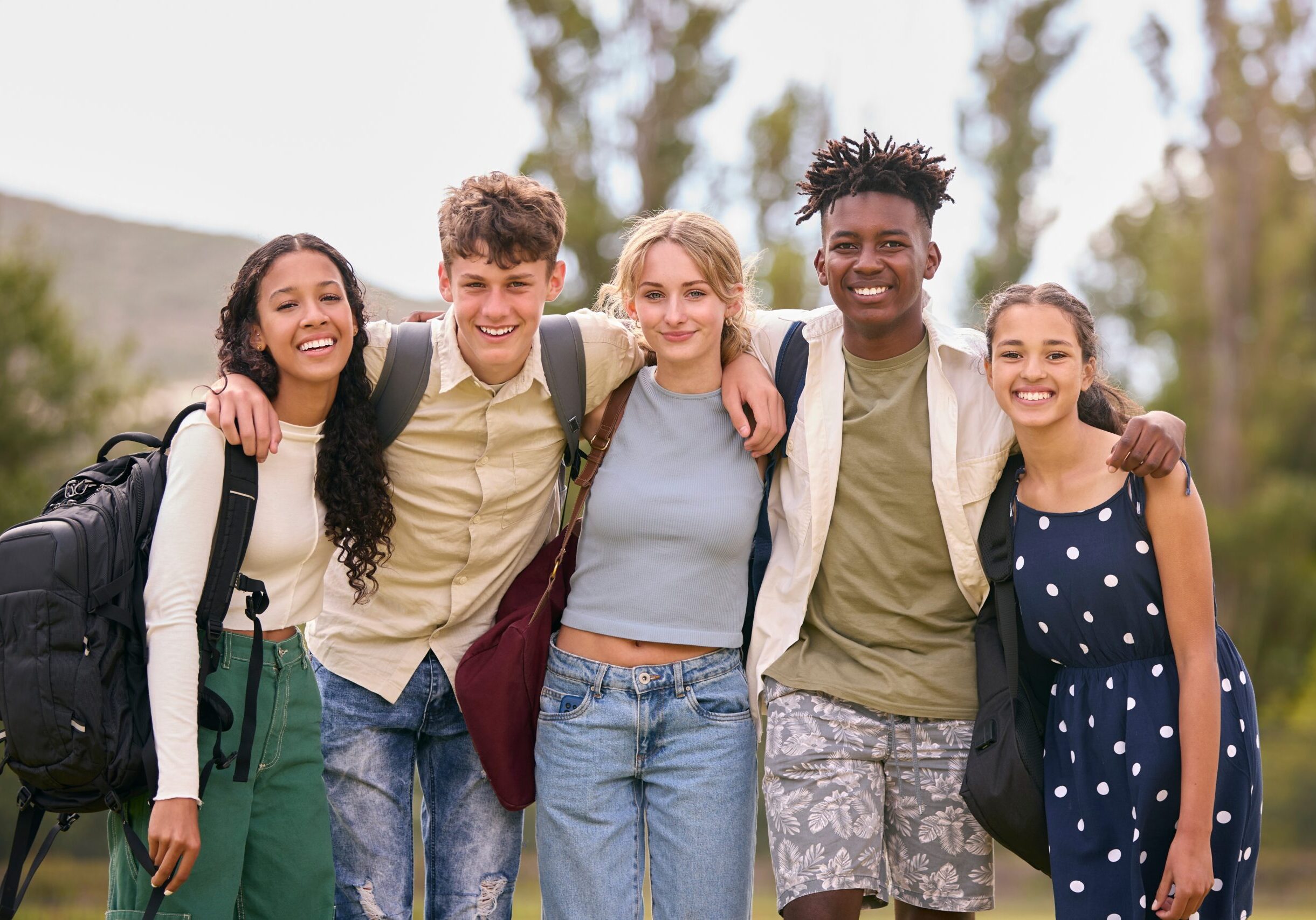 Portrait,Of,Multi-cultural,Secondary,Or,High,School,Students,Hugging,Outdoors